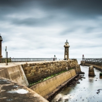 a couple of lighthouse on a solid wharf