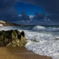 coastal town under stormy clouds