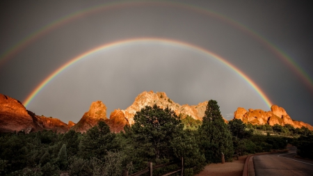 awesome rainbow over desert cliffs - rainbow, fence, desert, road, bushes, cliffs