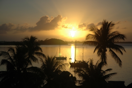 Beautiful sunset over Tropical Paradise Island Bora Bora Tahiti Polynesia - calm, lagoon, society, boat, evening, island, french, polynesia, tahiti, holiday, zen, twilight, south, sun, trees, beautiful, set, sea, ocean, palm, islands, boats, happiness, tranquility, sunset, bora bora, dusk, retreat