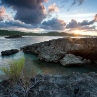 sunrise over rocky ocean inlet