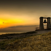 bell on a coastal hill at sunset