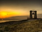 bell on a coastal hill at sunset