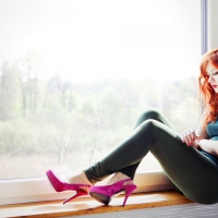 Beautiful girl Redhead in Window