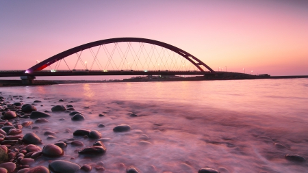 pink sunset over a coastal bridge in germany - pink, stones, sunset, sea, bridge, coast