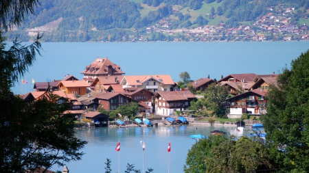 town of iseltwald on lake brienz switzerland - lake, mountains, town, trees, boats