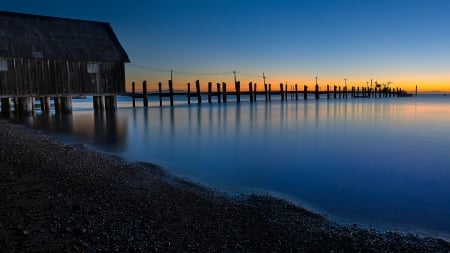 old pier on a black beach at twilight - old, black, beach, pier, sea, twilight