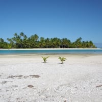 Deserted white sand beach and blue lagoon sea at One Foot Island Aitutaki Polynesia