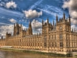 westminster abbey along the thames river hdr