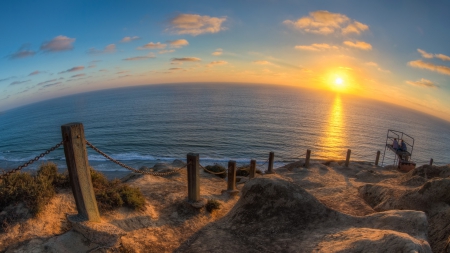 rocky cliff down to the sea in san diego - tower, cliff, rocks, people, chain, sunset, sea