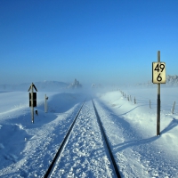 train tracks through a foggy winter day