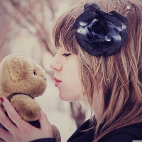 Girl kissing teddy bear