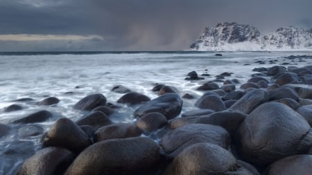 amazing black stones on a seashore - shore, foam, overcast, cliff, waves, sea, stones