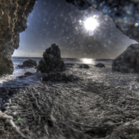 splashing waves in a sheshore grotto hdr