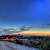 road down to a seaside town at dusk