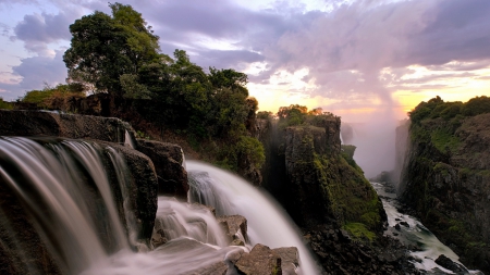 the mighty victoria falls gorge in zimbabwe - gorge, spray, trees, sundown, waterfalls, rocks