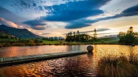 round rocks in a lovely pond - sundown, pond, dock, mountains, rocks