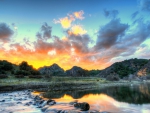 fiery sunrise over river in the coutryside hdr