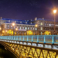 a beautiful paris bridge under sraty skies