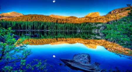 Early Moon Reflecting - moon, trees, water, blue, log, forest, reflection, leaves, mountain, nature, green, lake, sky