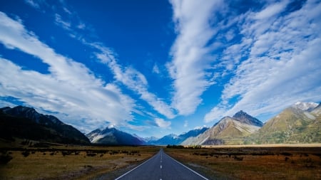 long road to the mountains - mountains, prairie, road, clouds