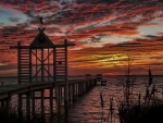 closed gates on pier at sunset