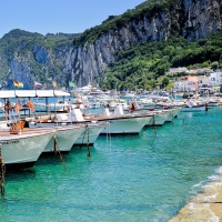 row of boats by a magnificent seaside town