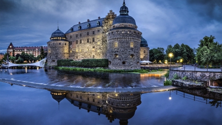 wonderful orebro castle in sweeden - trees, evening, castle, river, lights