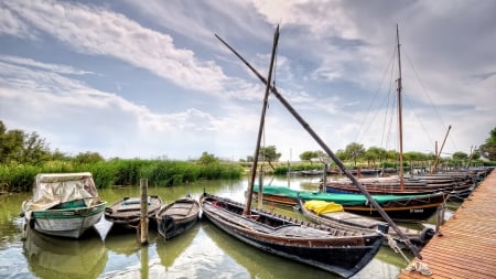 older fleet of boats docked in spain - clouds, boats, marina, docks, harbor