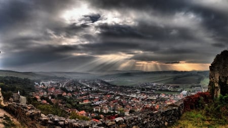 fantastic sunbeams over a town - hills, town, clouds, sunbeams