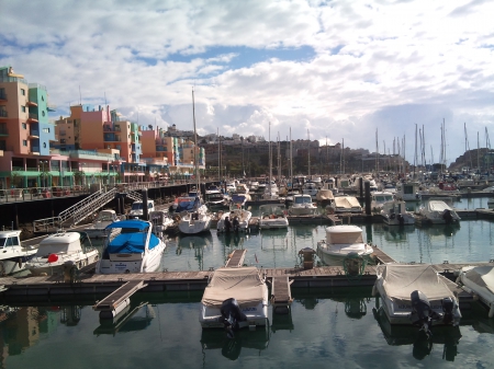 Albufeira harbour from afar - sky, building, boats, harbour, water, docks, view, clouds, holiday