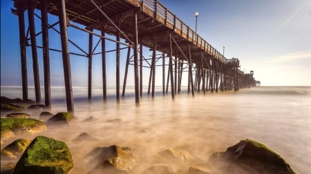 wooden pier above a misty sea - shore, wooden, mist, moss, sea, rocks, pier