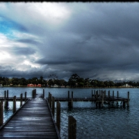 docks on a lake under stormy sky