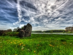 ruins returning to nature by a river hdr