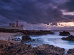 beautiful portuguese lighthouse on rocky shore