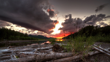 fabulous sunset over a pile of logs by a river - sunset, clouds, river, logs