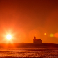 marvelous sunrise over church on the plain