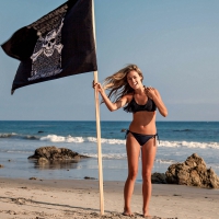 Bikini Model on Malibu Beach with Pirate Flag