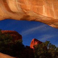 starry night through canyon arch in utah