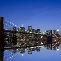 brooklyn bridge reflected in mirrored east river