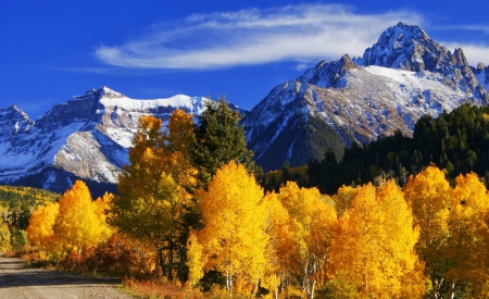 Autumn in the mountain - hills, yellow, landscape, mountain, peak, cliffs, golden, nice, sky, clouds, falling, trees, beautiful, snowy, slope, colors, lovely, fall, autumn, foliage, rocks