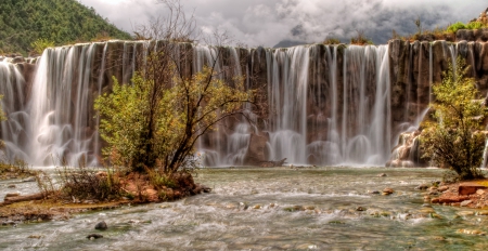 gorgeous waterfall in lijiang china - trees, cliff, river, clouds, mountains, waterfall