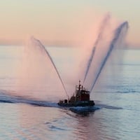 Fireboat spraying at sunrise