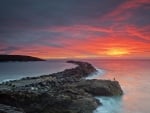 fishing off a stone wharf at sunrise