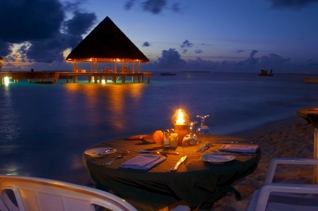 Romantic Sea View Dinner - beach, paradise, candles, water, sunset, villa, view, dine, romance, holiday, lagoon, food, sand, dusk, bungalow, dinner, candlelight, ocean, night, tropical, exotic, eat, romantic, sea