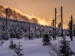 sunset over a wintry hill