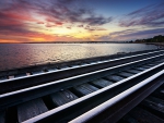 dual rail tracks along a shore at twilight