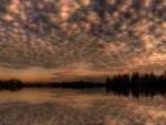 puffy clouds reflected on a lake