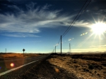 midday sun over highway through the prairie