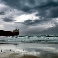 tanker ship beached under stormy skies